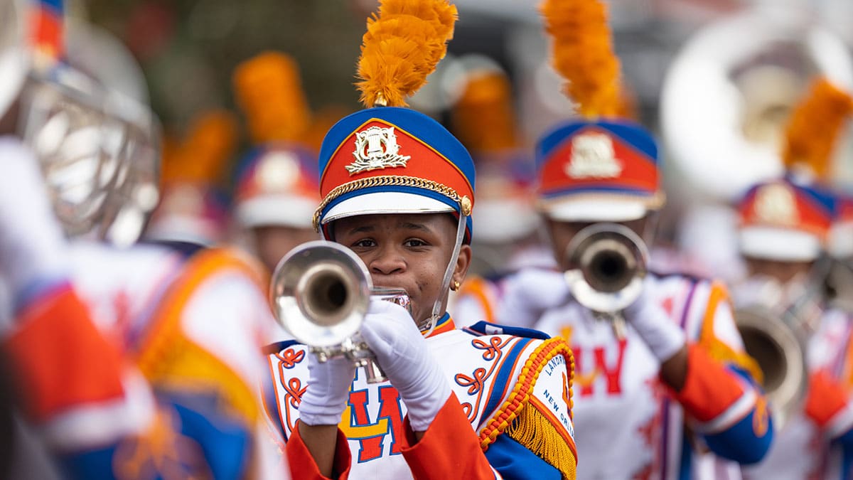 Marching band performing in a vibrant parade
